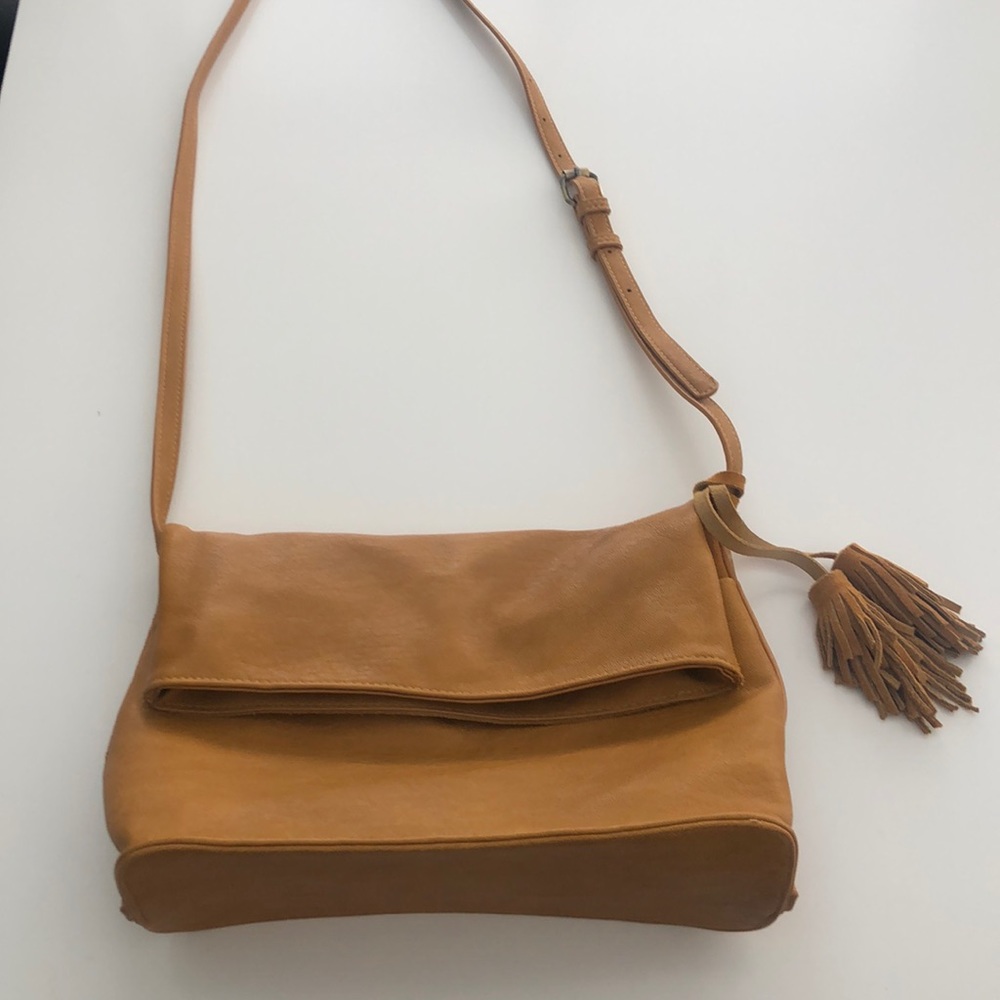 Cross body suede bag with adjustable strap and cute tassel detail.